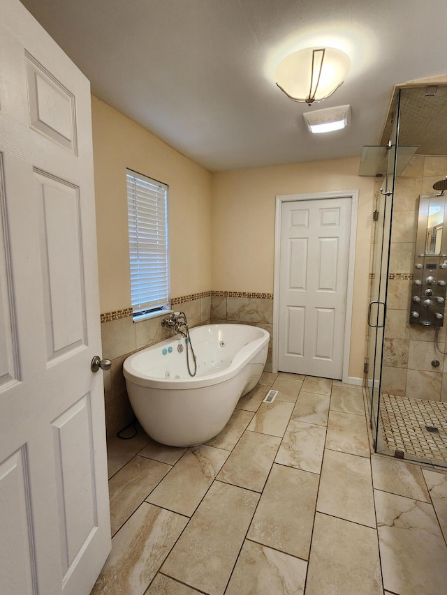 bathroom with independent shower and bath and tile walls