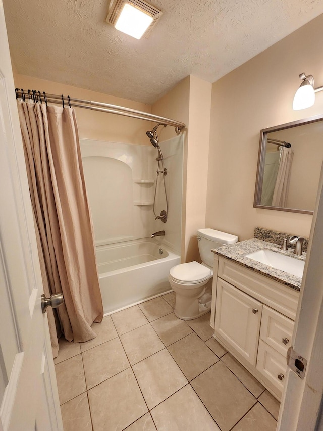 full bathroom featuring tile patterned floors, a textured ceiling, vanity, shower / tub combo with curtain, and toilet