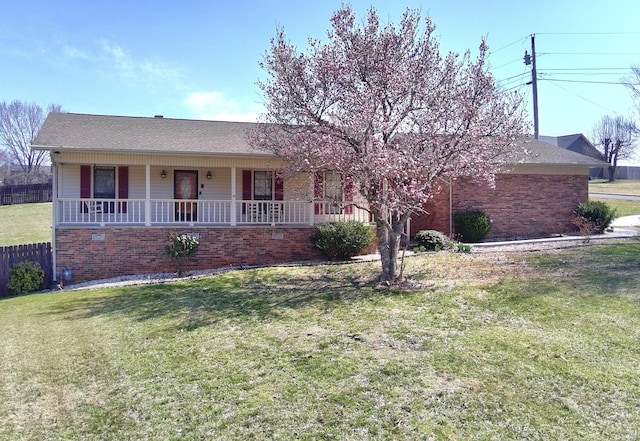 single story home with a front lawn and covered porch