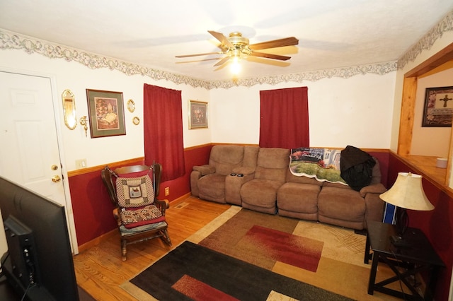 living area featuring ceiling fan and wood finished floors