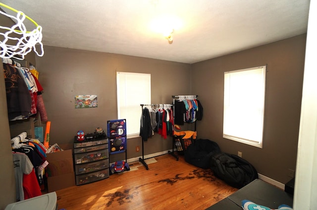 bedroom with baseboards and wood finished floors