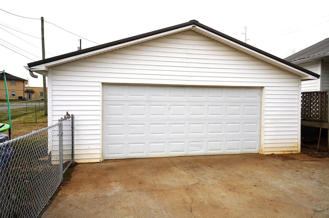 detached garage featuring fence