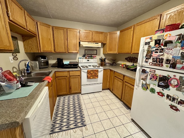 kitchen with a textured ceiling, white appliances, light tile patterned floors, and sink