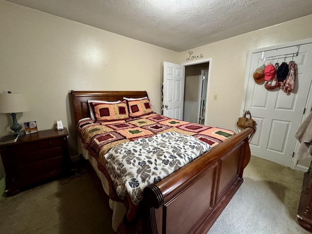 bedroom with a textured ceiling and light carpet