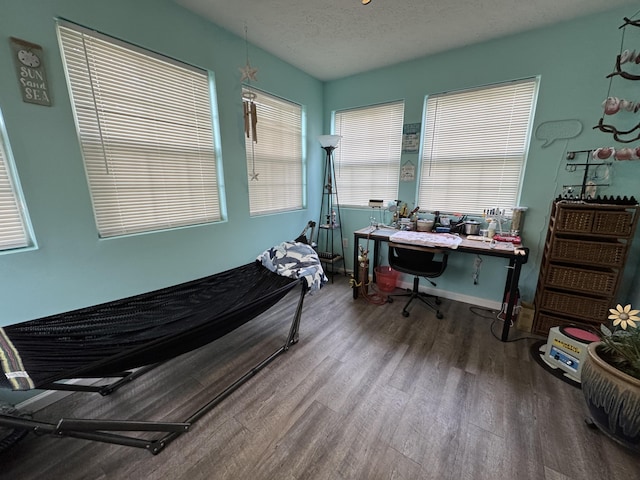 bedroom featuring a textured ceiling and hardwood / wood-style flooring