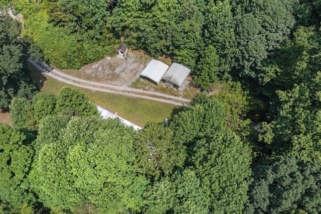 bird's eye view with a wooded view