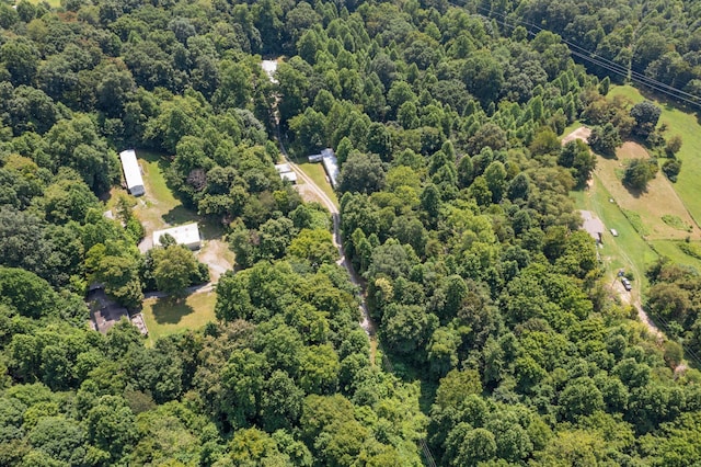 birds eye view of property with a view of trees
