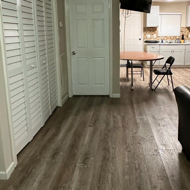 dining area featuring dark wood-type flooring