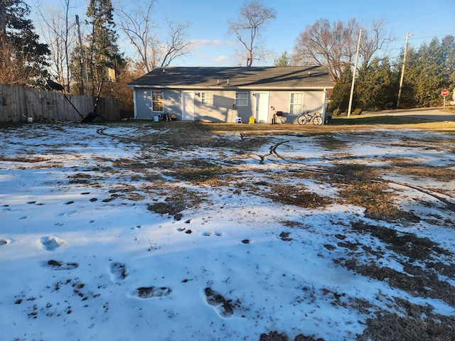 view of snow covered rear of property