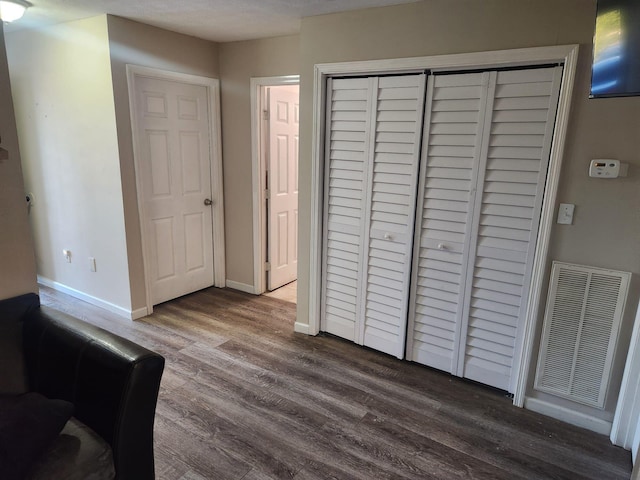 bedroom featuring hardwood / wood-style floors and a closet