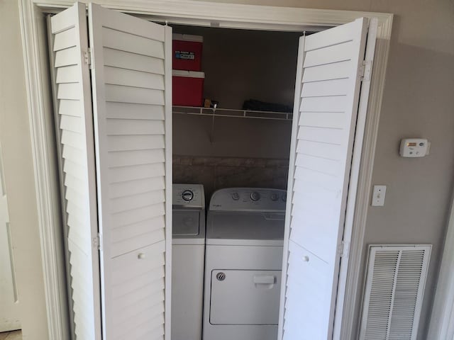 clothes washing area with independent washer and dryer