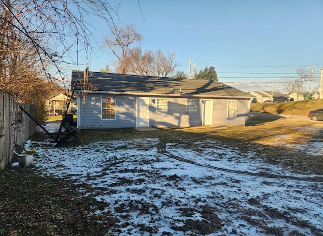 view of snow covered rear of property