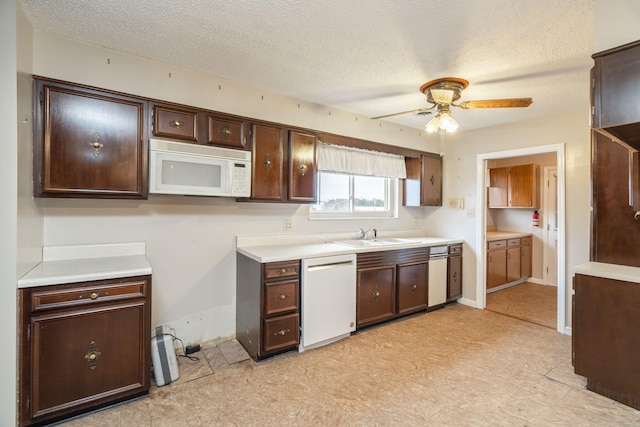 kitchen with sink, white appliances, ceiling fan, dark brown cabinets, and a textured ceiling