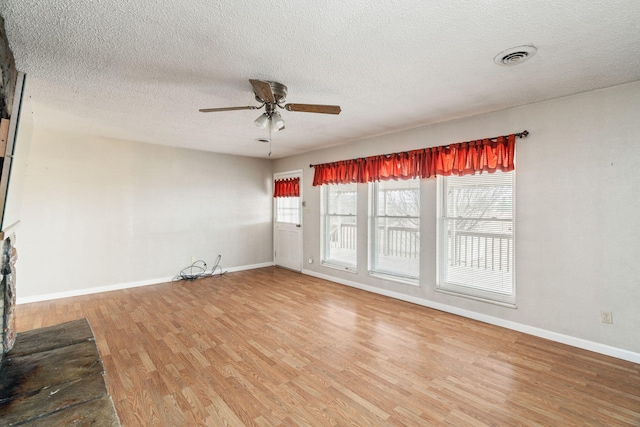 unfurnished room with hardwood / wood-style flooring, a textured ceiling, and ceiling fan