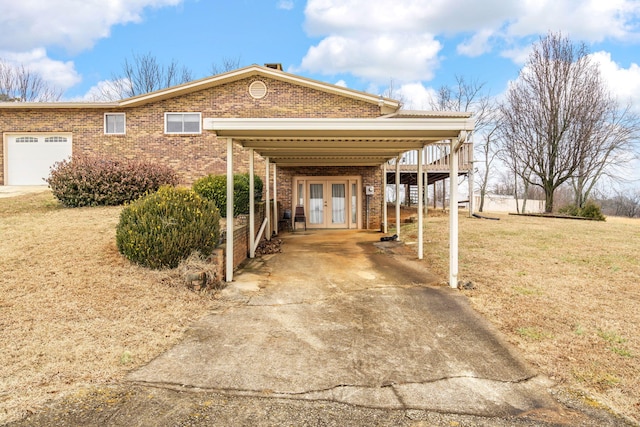 view of front of house with a garage, a front lawn, and french doors