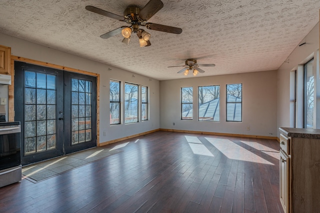 empty room featuring wood-type flooring, ceiling fan, a textured ceiling, and french doors