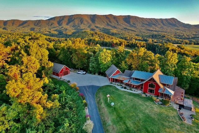 view from above of property featuring a forest and a mountain backdrop