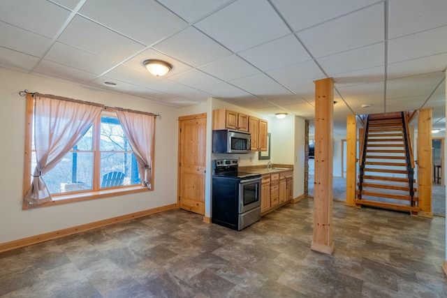 kitchen featuring a paneled ceiling, appliances with stainless steel finishes, sink, and light brown cabinets