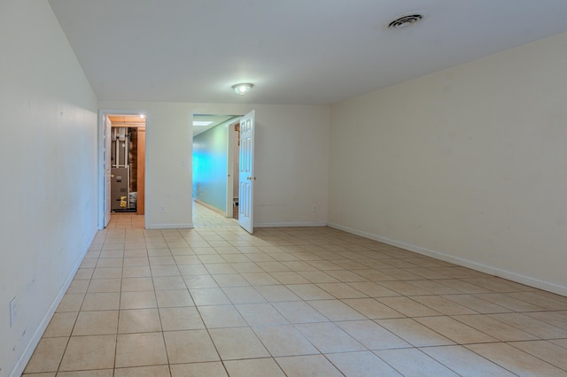 unfurnished room with light tile patterned floors