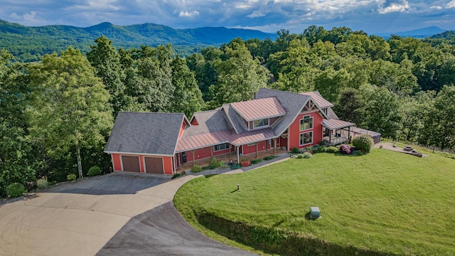 view of subject property featuring a forest and a mountainous background