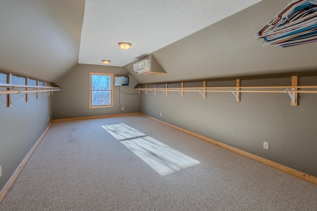 spacious closet featuring carpet floors and vaulted ceiling