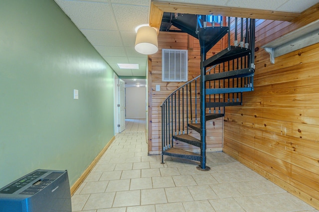 stairs featuring a drop ceiling