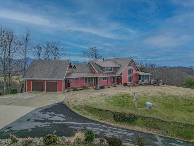 view of front of home featuring a garage and a front lawn