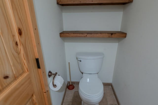 bathroom with tile patterned flooring and toilet