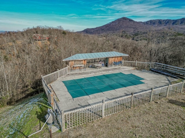 view of swimming pool with a mountain view and a patio area