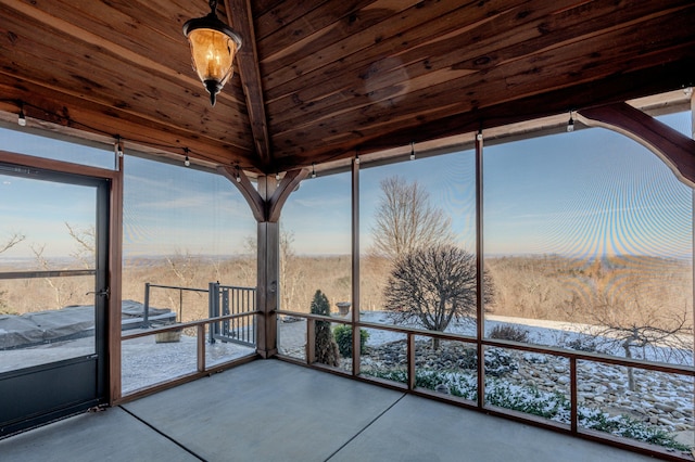 unfurnished sunroom featuring wood ceiling and vaulted ceiling