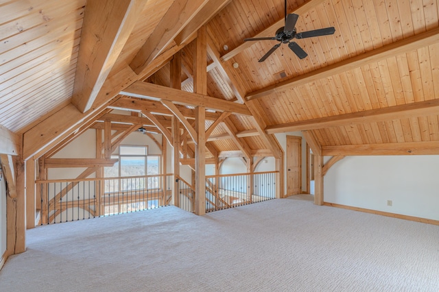 additional living space with wood ceiling, ceiling fan, carpet flooring, and vaulted ceiling with beams