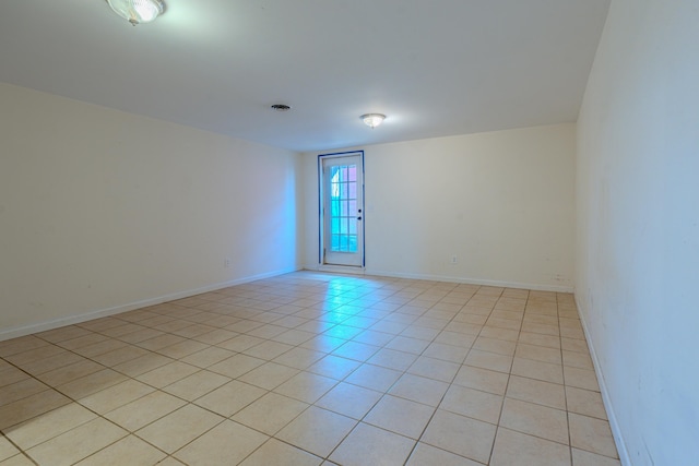 unfurnished room featuring light tile patterned floors