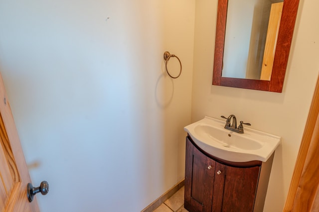 bathroom featuring vanity, tile patterned flooring, and baseboards