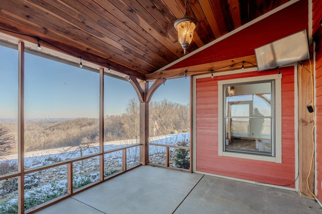 unfurnished sunroom with lofted ceiling and wooden ceiling