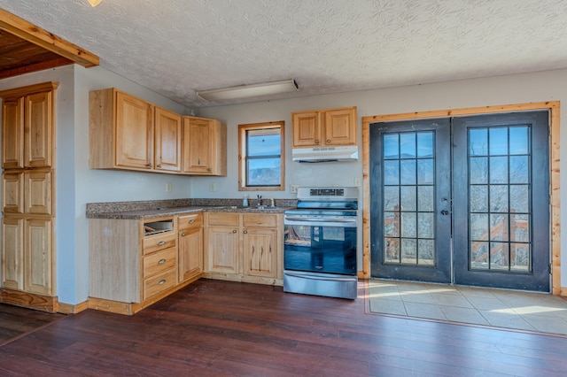 kitchen featuring stainless steel electric range oven, under cabinet range hood, dark wood-style flooring, french doors, and light brown cabinets