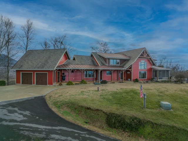 view of front of property featuring a garage and a front lawn