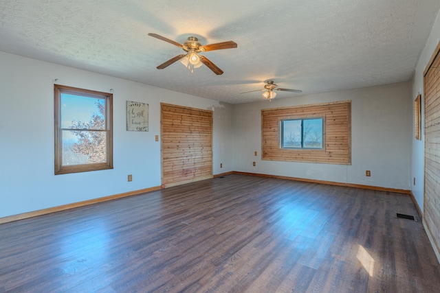 unfurnished bedroom with ceiling fan, dark hardwood / wood-style floors, and a textured ceiling