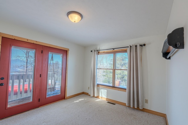 doorway featuring light colored carpet