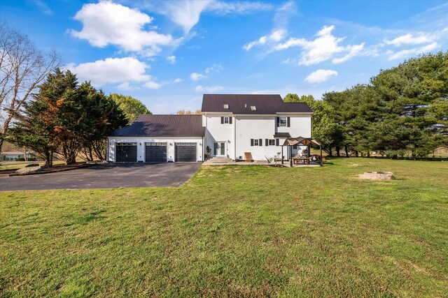 2940 Beecarter Rd, Dandridge, TN 37725 - rear view of property with a lawn, entry steps, metal roof, a garage, and driveway