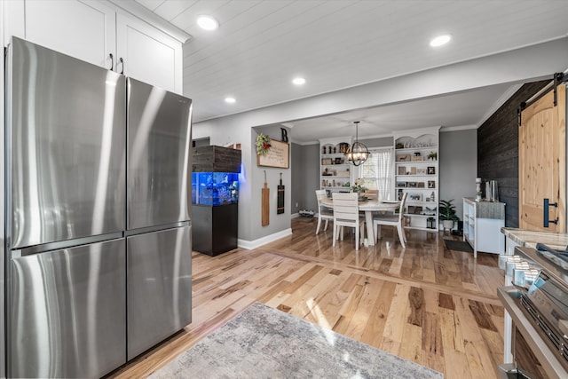 2940 Beecarter Rd, Dandridge, TN 37725 - kitchen with baseboards, freestanding refrigerator, a barn door, and light wood finished floors