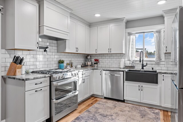 2940 Beecarter Rd, Dandridge, TN 37725 - kitchen featuring light stone counters, a sink, white cabinets, and stainless steel appliances