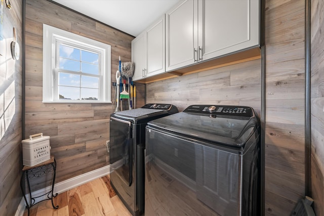 2940 Beecarter Rd, Dandridge, TN 37725 - washroom featuring wood walls, light wood-type flooring, independent washer and dryer, and cabinet space