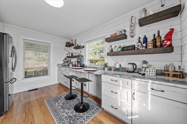 2940 Beecarter Rd, Dandridge, TN 37725 - bar featuring ornamental molding, light wood-type flooring, freestanding refrigerator, and visible vents