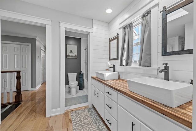 2940 Beecarter Rd, Dandridge, TN 37725 - full bathroom featuring double vanity, a sink, toilet, and wood finished floors