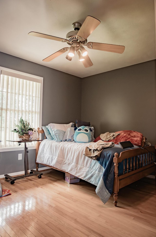 bedroom with wood finished floors and a ceiling fan