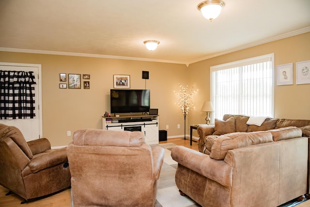 living area with crown molding, light wood-type flooring, and baseboards