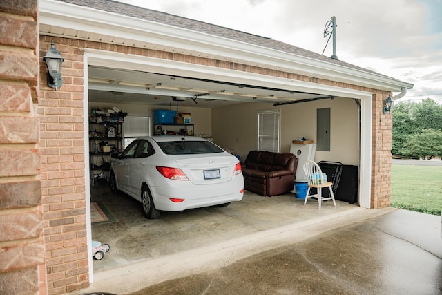 garage featuring electric panel and a garage door opener