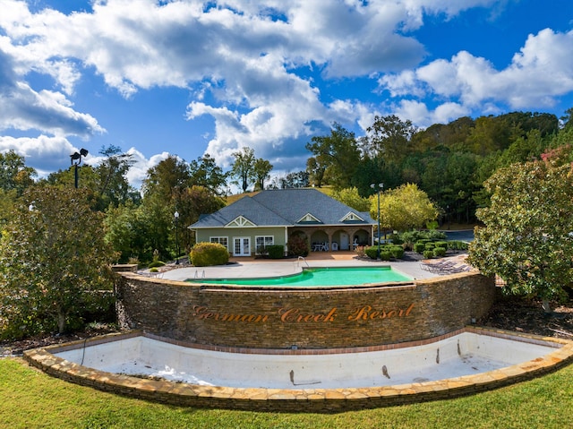 view of swimming pool with french doors