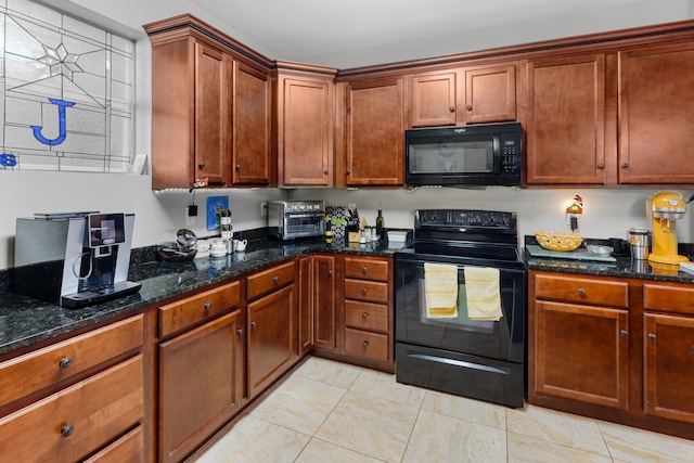 kitchen with dark stone countertops and black appliances