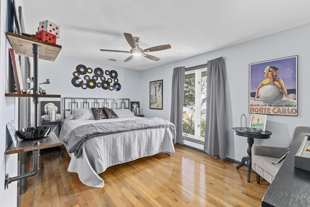 bedroom with hardwood / wood-style flooring and ceiling fan